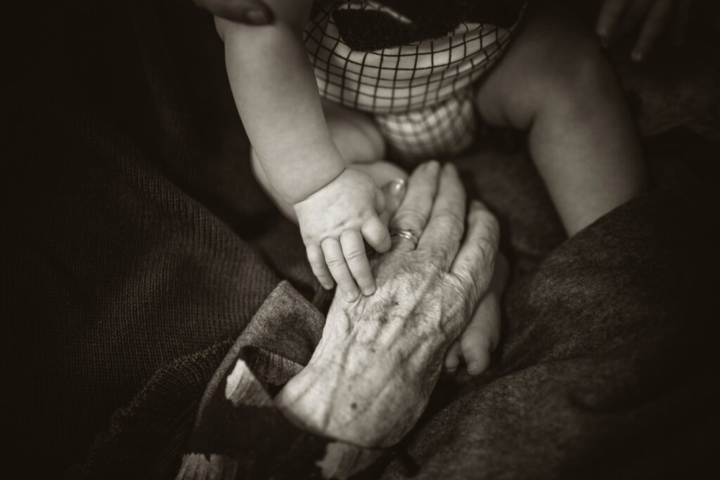 baby holding grandparent's hand
